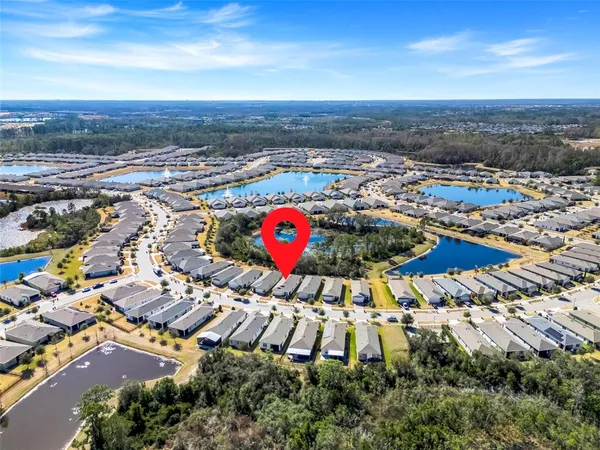 an aerial view of residential houses with outdoor space
