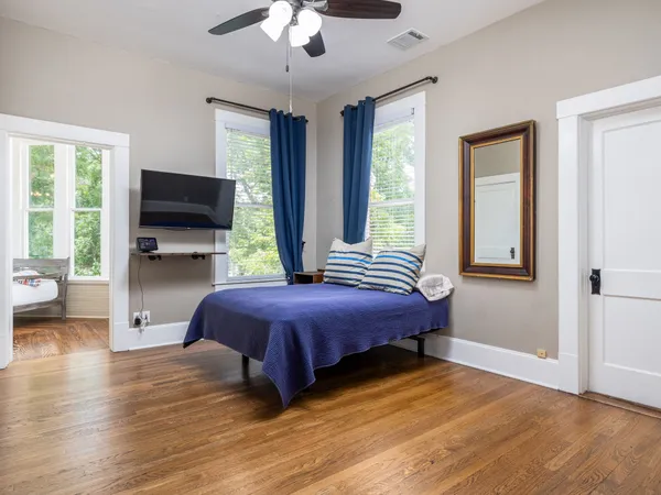 a spacious bathroom with a toilet a sink and mirror