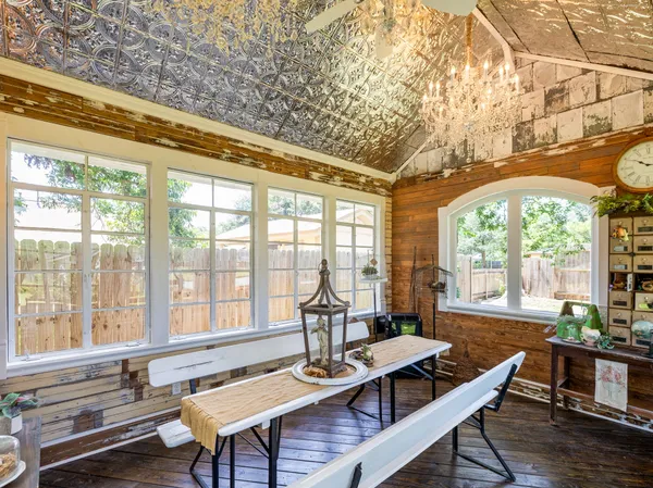 an aerial view of house with yard and trees in the background