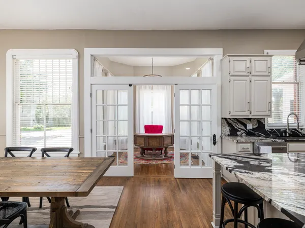 a kitchen with stainless steel appliances kitchen island granite countertop a stove a sink and a refrigerator