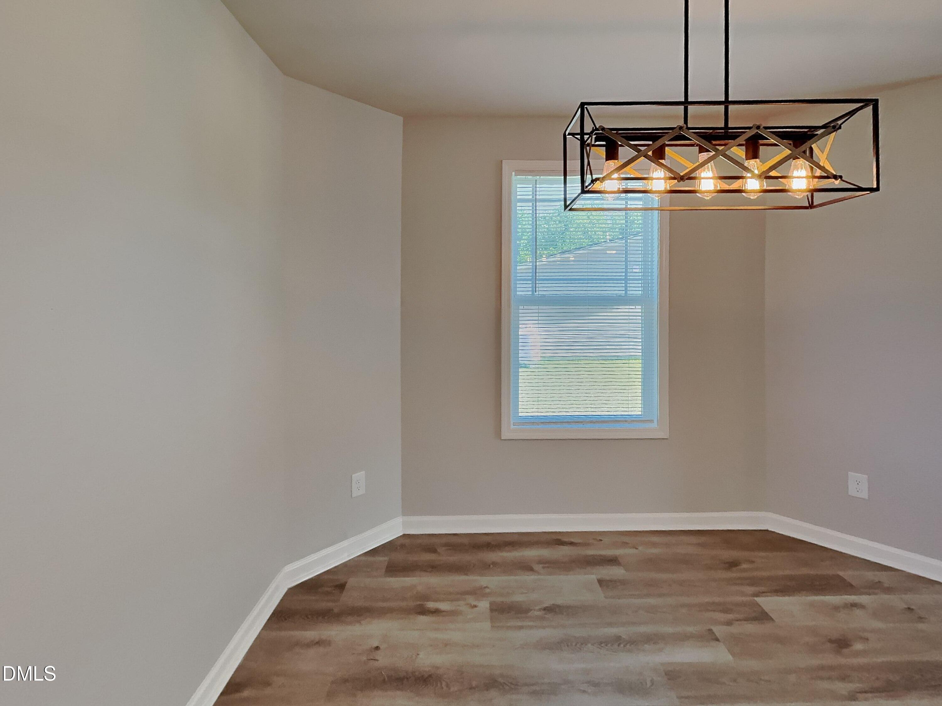 123 Willow Ridge Circle Willow Spring, NC 27592 - Photo 4 of 15 a room with a chandelier fan and wooden floor