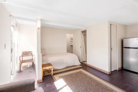 a blue sign sitting in the middle of a forest