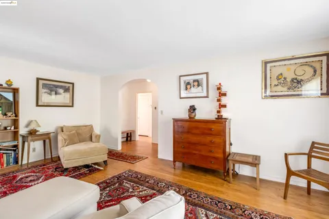 a living room with furniture large window and a fireplace
