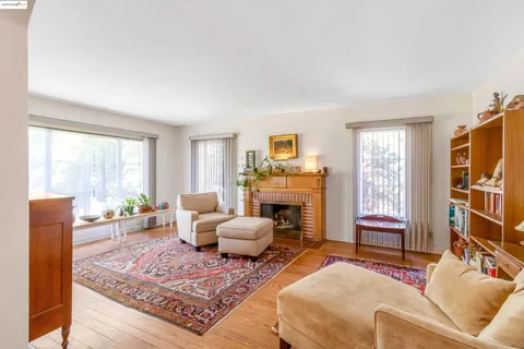 a living room with furniture a fireplace and a window