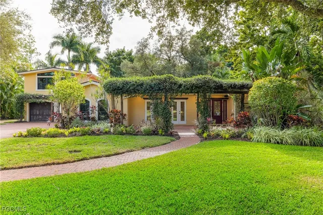 a view of a house with a yard and sitting area