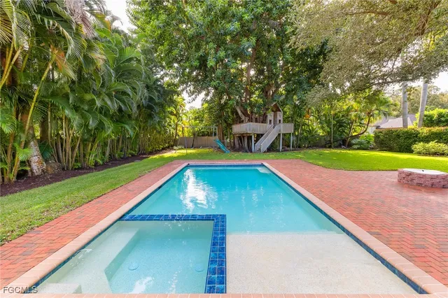 a small pool with trees in the background