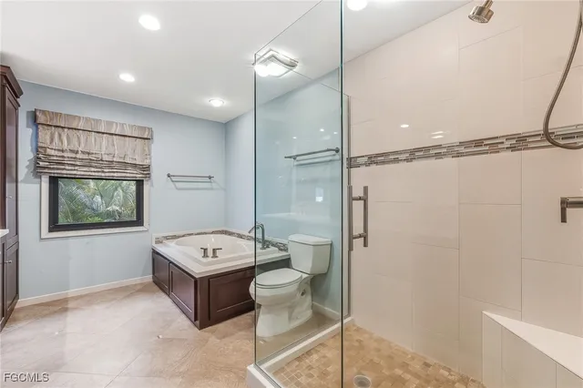 a bathroom with a double vanity sink toilet and shower