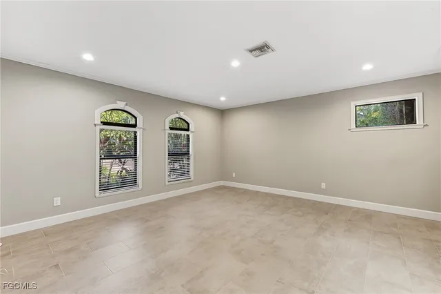 an empty room with windows and closet