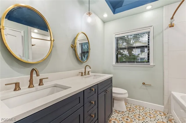 a bathroom with 2 sink and a mirror