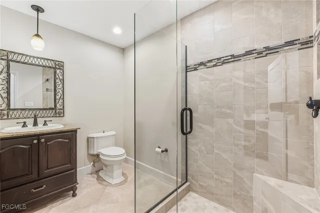 a bathroom with a toilet sink and shower