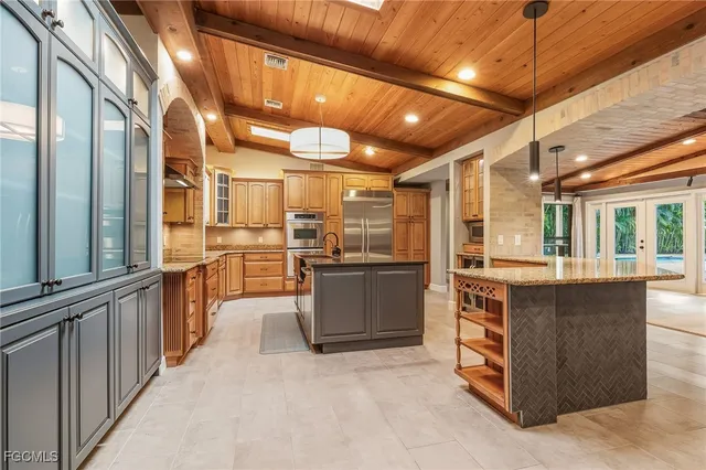 a kitchen with stainless steel appliances granite countertop a stove and a refrigerator