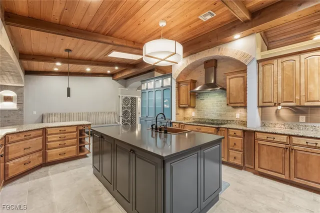 a kitchen with granite countertop a sink and cabinets