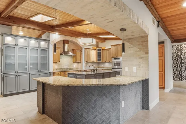 a view of a kitchen with kitchen island a sink and a counter top space