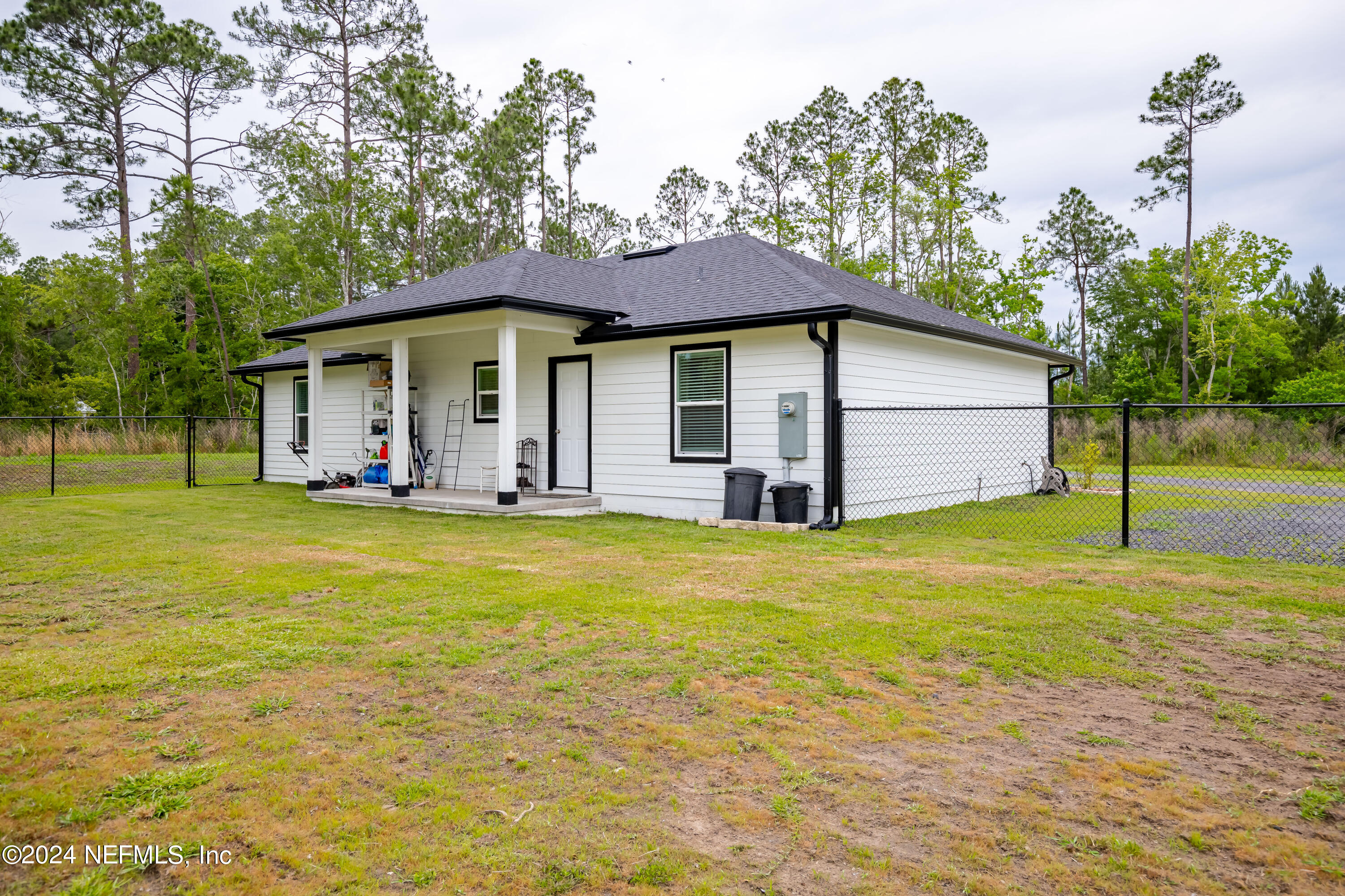 6477 Keith Griffis Circle Macclenny, FL 32063 - Photo 13 of 30 a front view of house with yard and seating area
