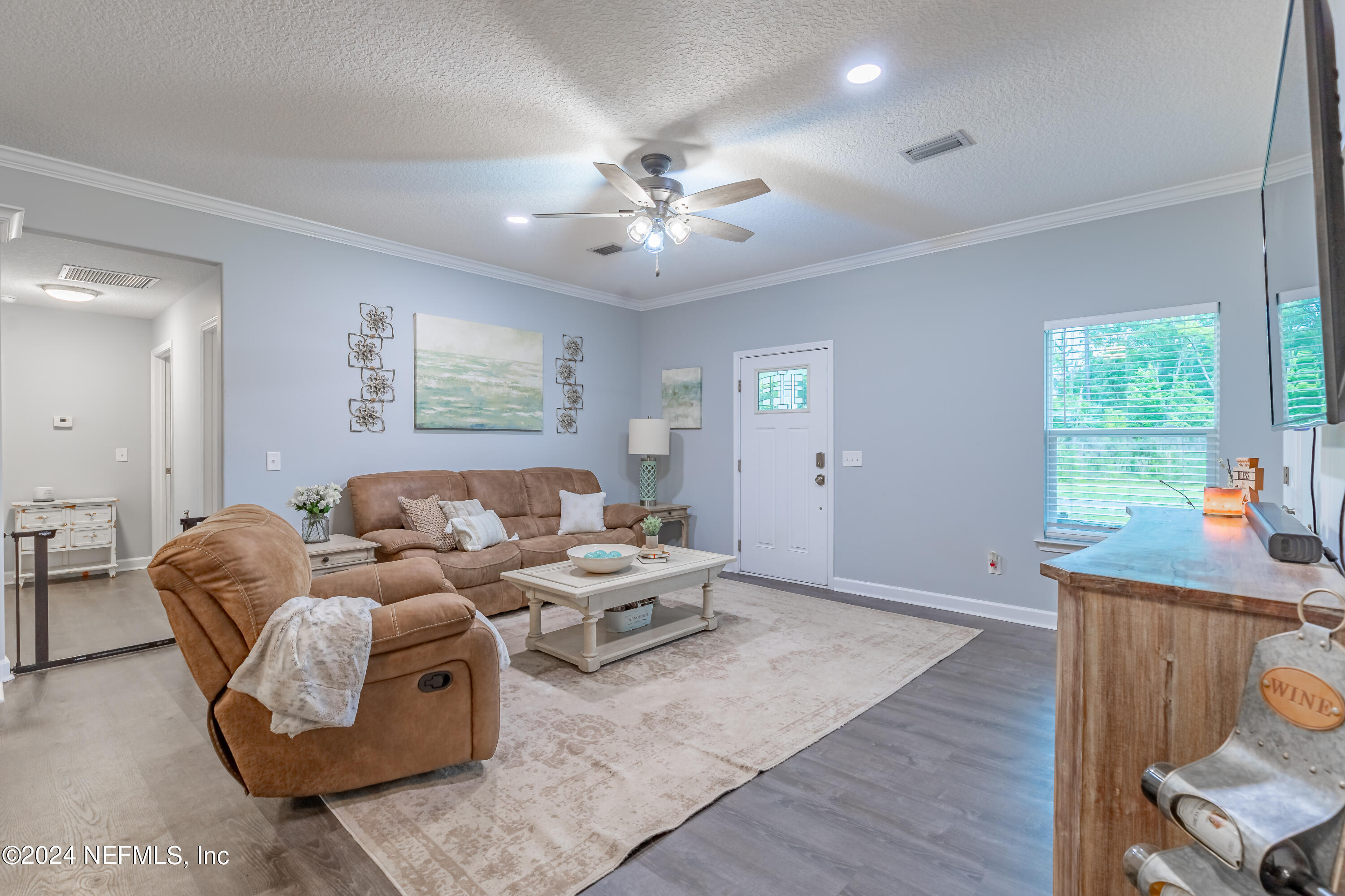 6477 Keith Griffis Circle Macclenny, FL 32063 - Photo 16 of 30 a living room with furniture and a window