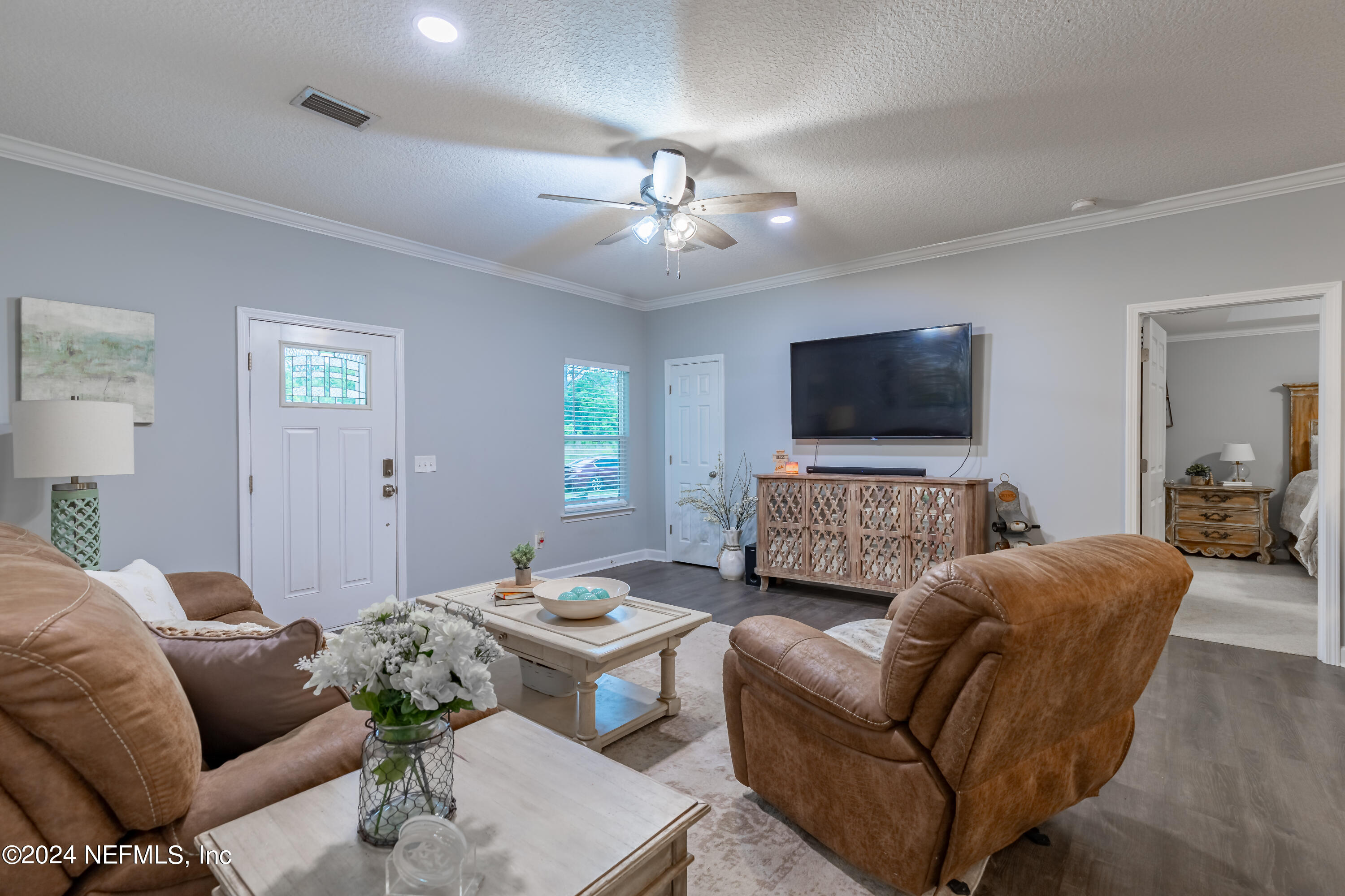 6477 Keith Griffis Circle Macclenny, FL 32063 - Photo 17 of 30 a living room with furniture and a flat screen tv