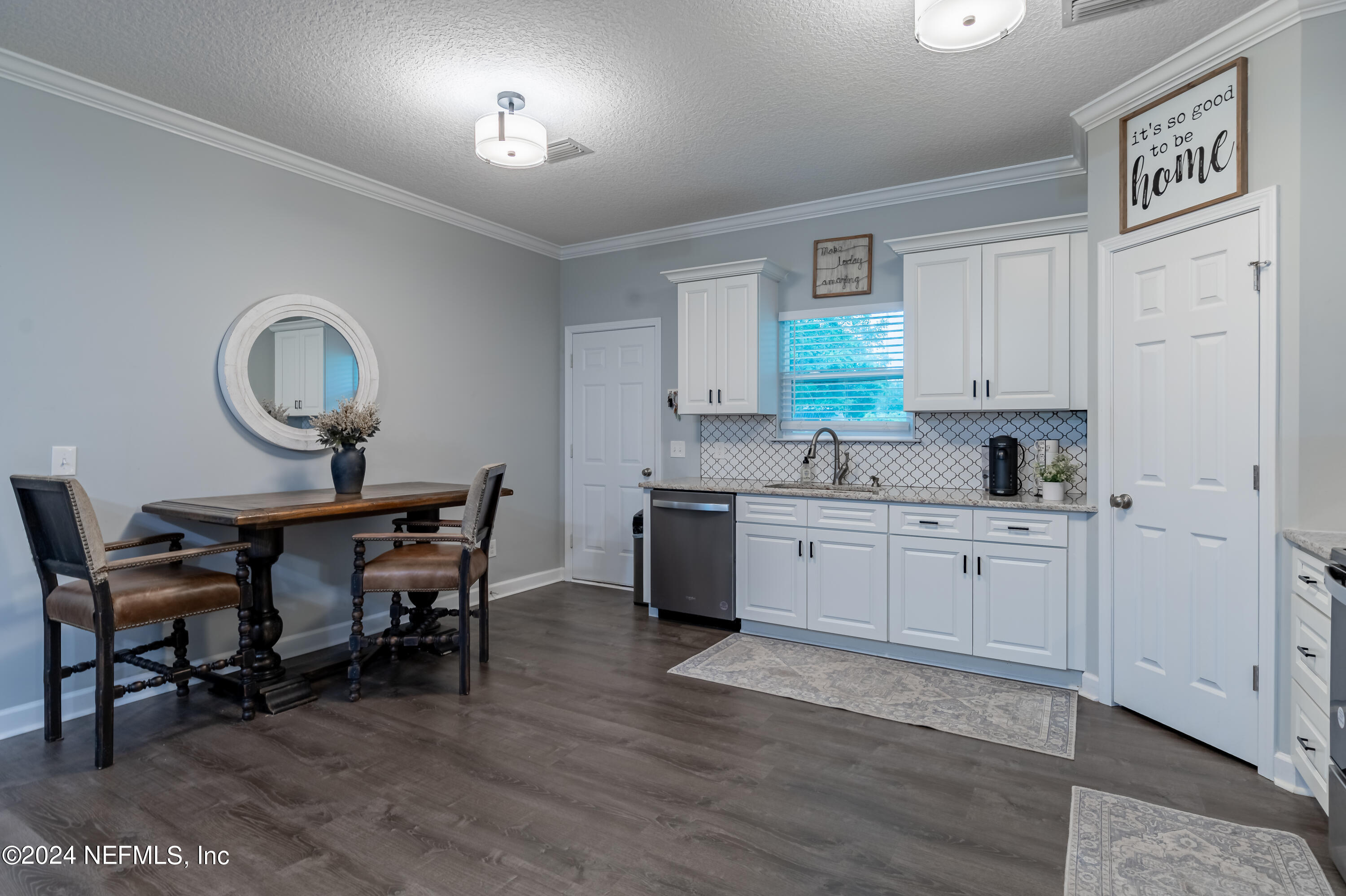6477 Keith Griffis Circle Macclenny, FL 32063 - Photo 18 of 30 a kitchen with a table chairs and a refrigerator