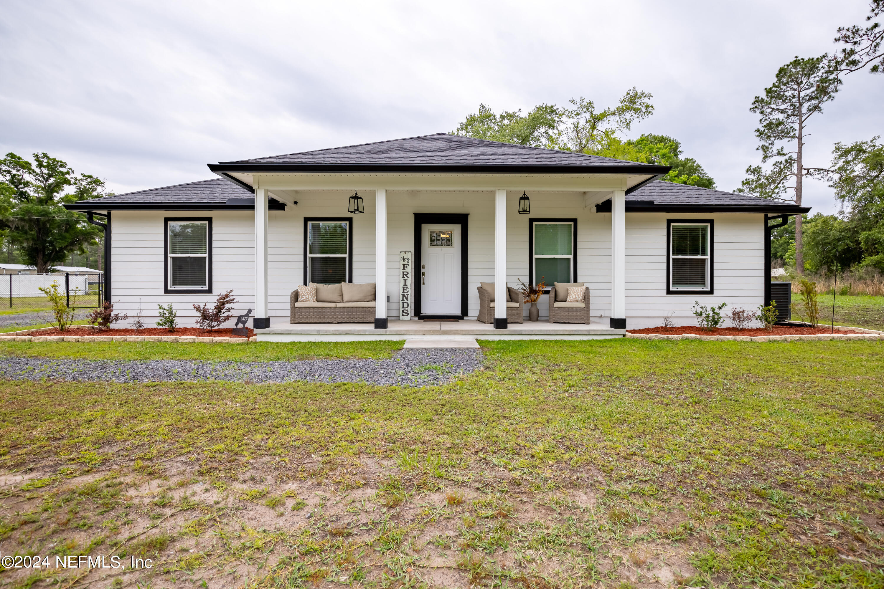 6477 Keith Griffis Circle Macclenny, FL 32063 - Photo 2 of 30 a view of a house with swimming pool and porch