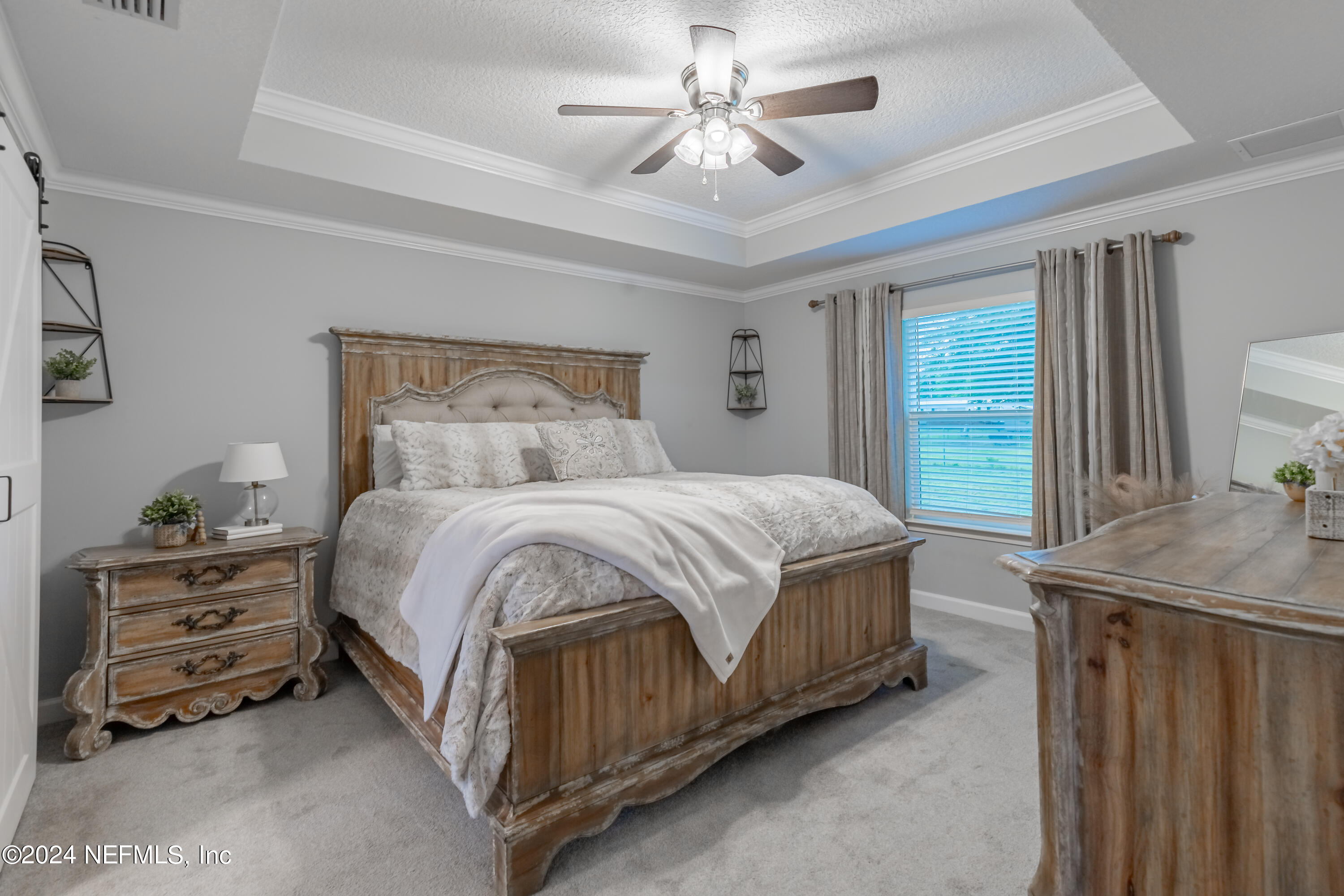 6477 Keith Griffis Circle Macclenny, FL 32063 - Photo 21 of 30 a bedroom with a bed and a chandelier