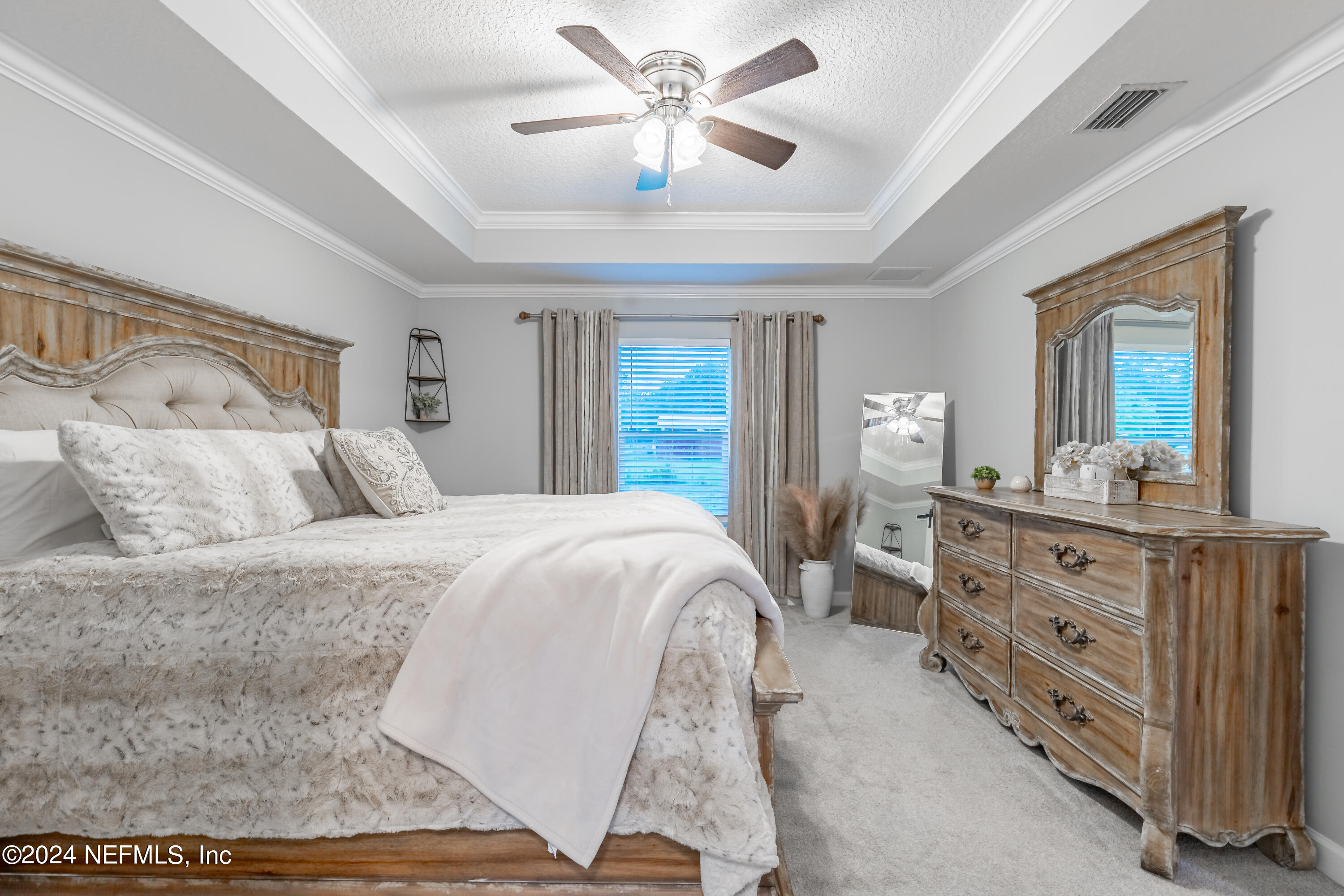 6477 Keith Griffis Circle Macclenny, FL 32063 - Photo 22 of 30 a spacious bedroom with a bed and a dresser
