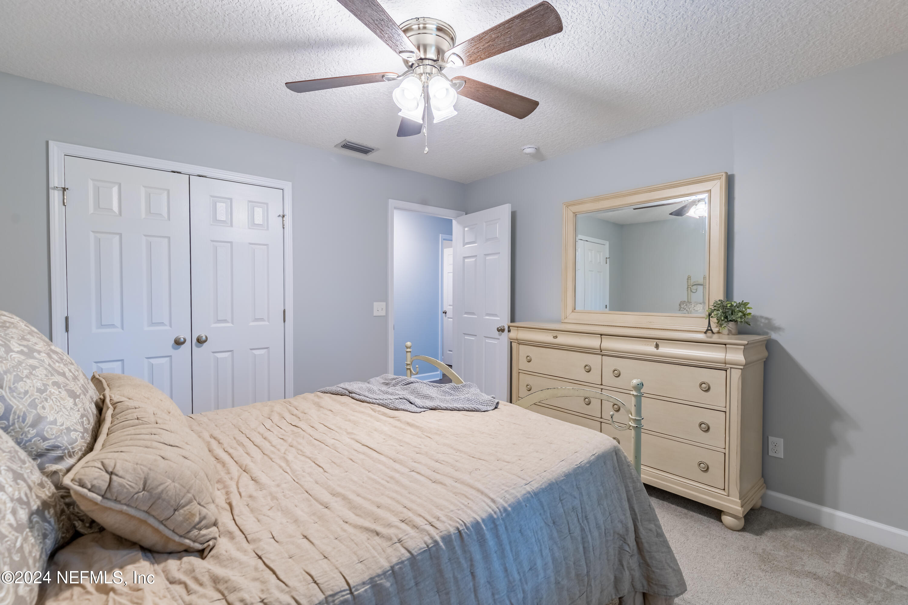 6477 Keith Griffis Circle Macclenny, FL 32063 - Photo 30 of 30 a bedroom with a large bed and a chandelier