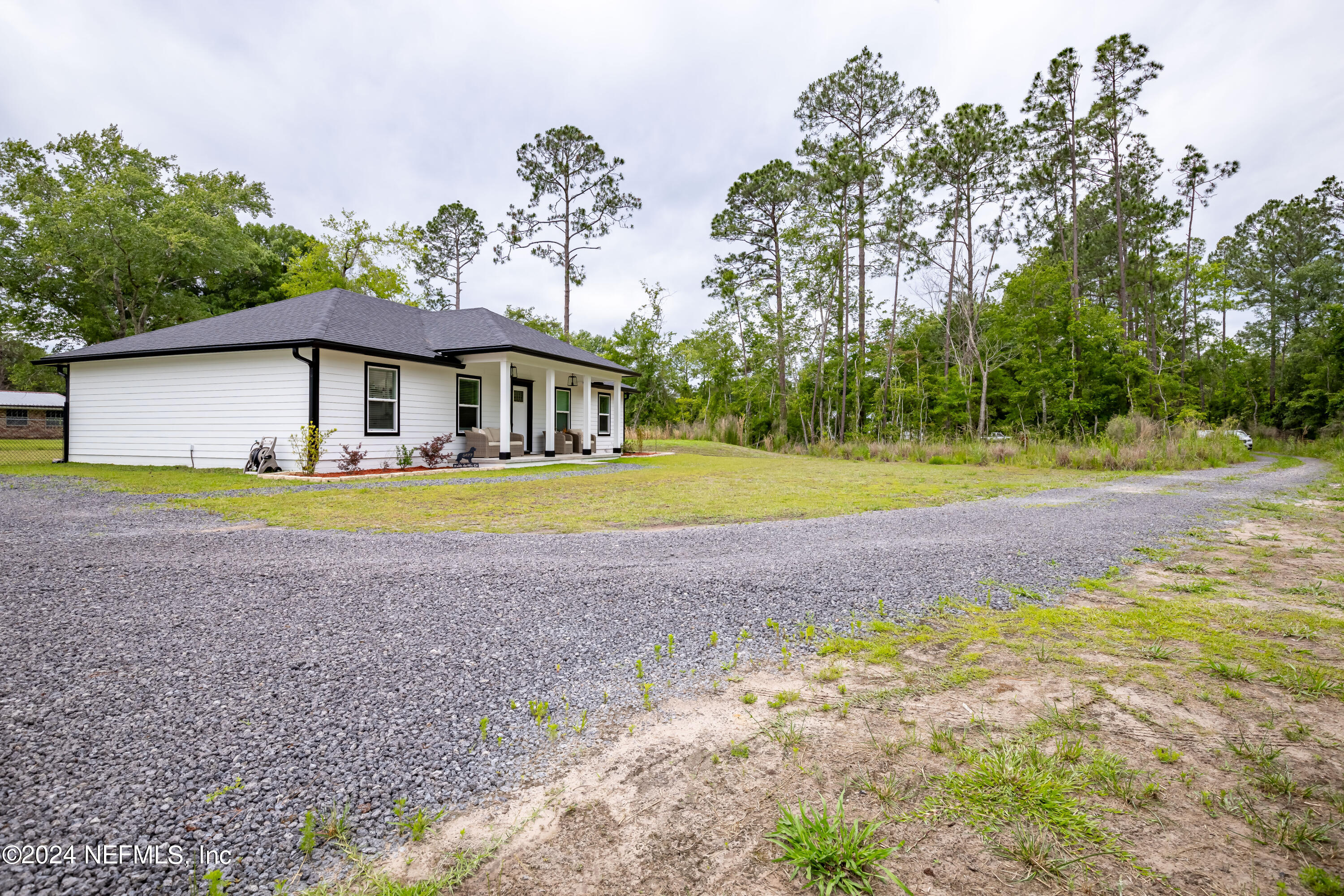 6477 Keith Griffis Circle Macclenny, FL 32063 - Photo 9 of 30 a view of a house with swimming pool and a yard
