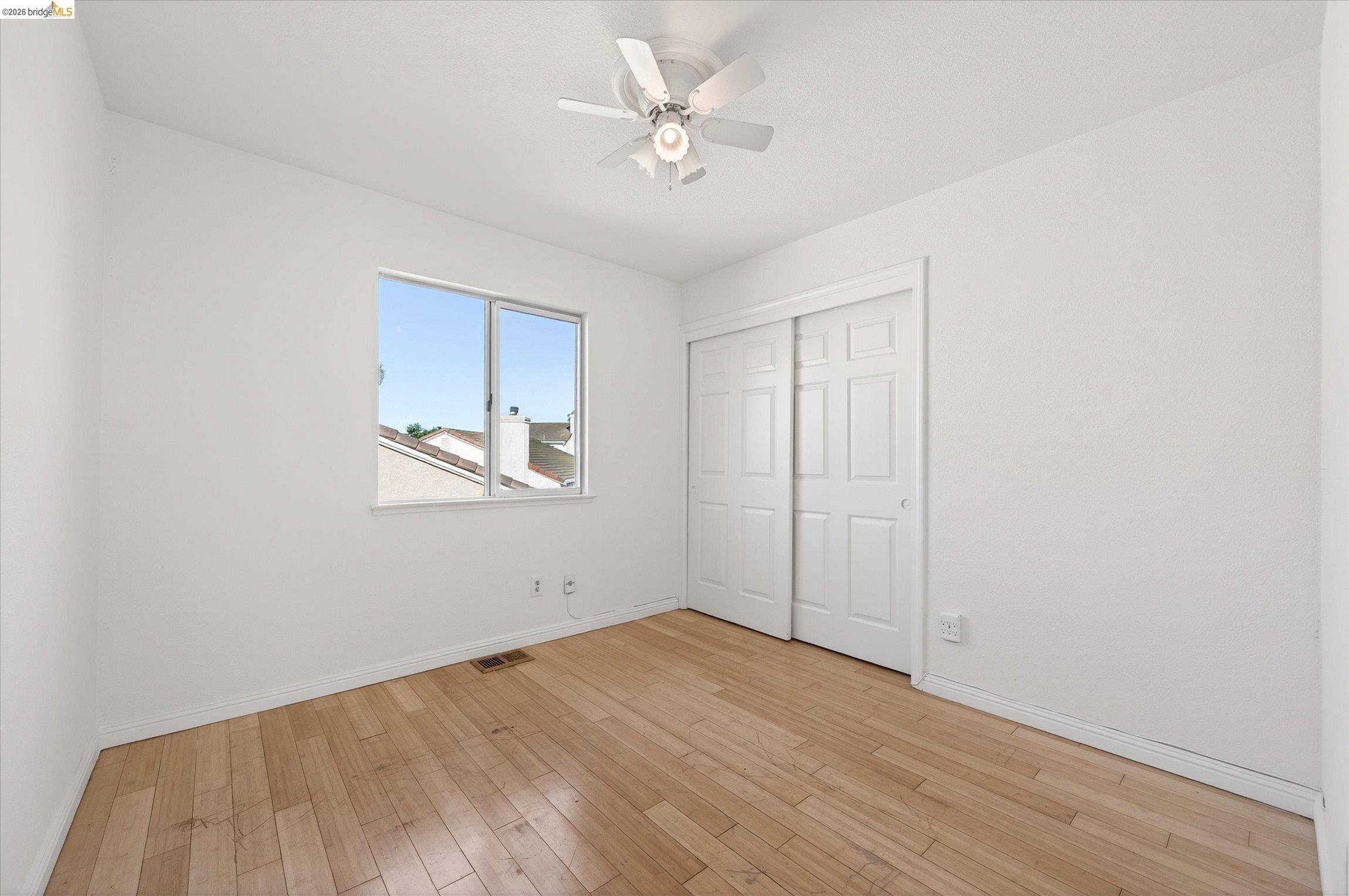 1120 Deerpark Road Oakley, CA 94561 - Photo 22 of 30 Room featuring wood-finish flooring, a double-pane window, and a ceiling fan with light fixture
