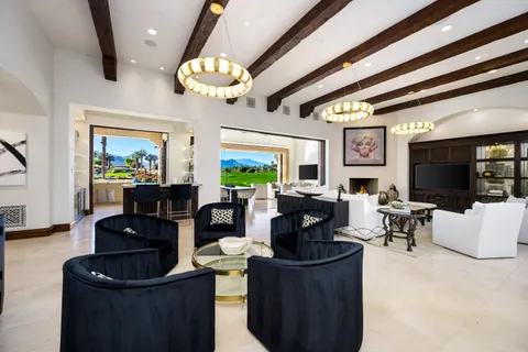 a spacious bedroom with a bed and a flat screen tv