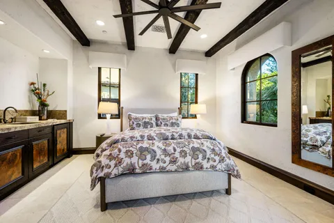 a bedroom with a large bed and a large window