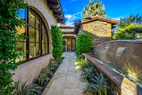 a view of a park with plants and palm trees