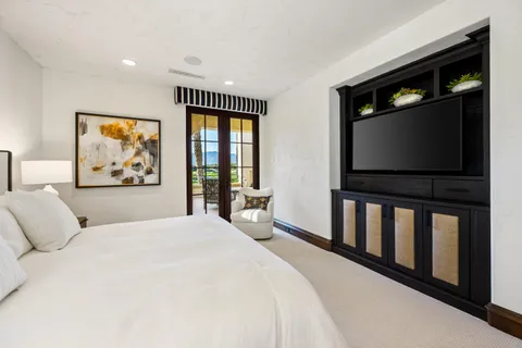 a front view of a house with swimming pool table and chairs