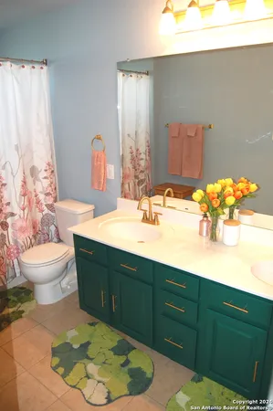 a bathroom with a sink toilet and mirror