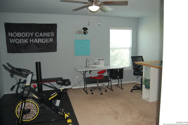 a view of a workspace with furniture and a window