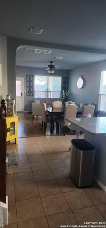 a living room with furniture a large window and a fireplace