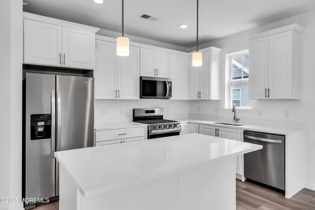 a view of a storage and utility room with washer and dryer