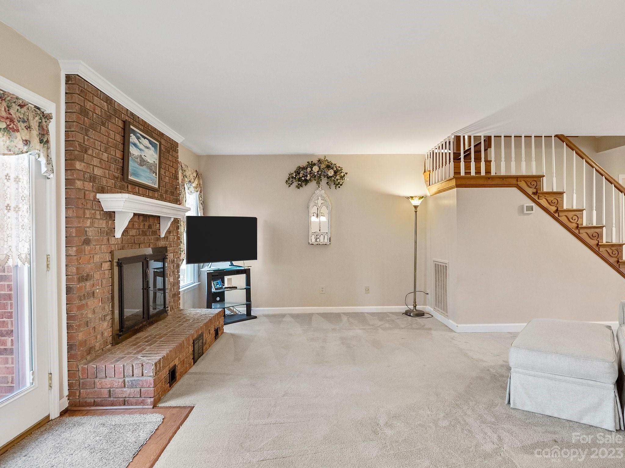 8211 Plott Road Charlotte, NC 28215 - Photo 11 of 38 a view of a livingroom with furniture and a flat screen tv