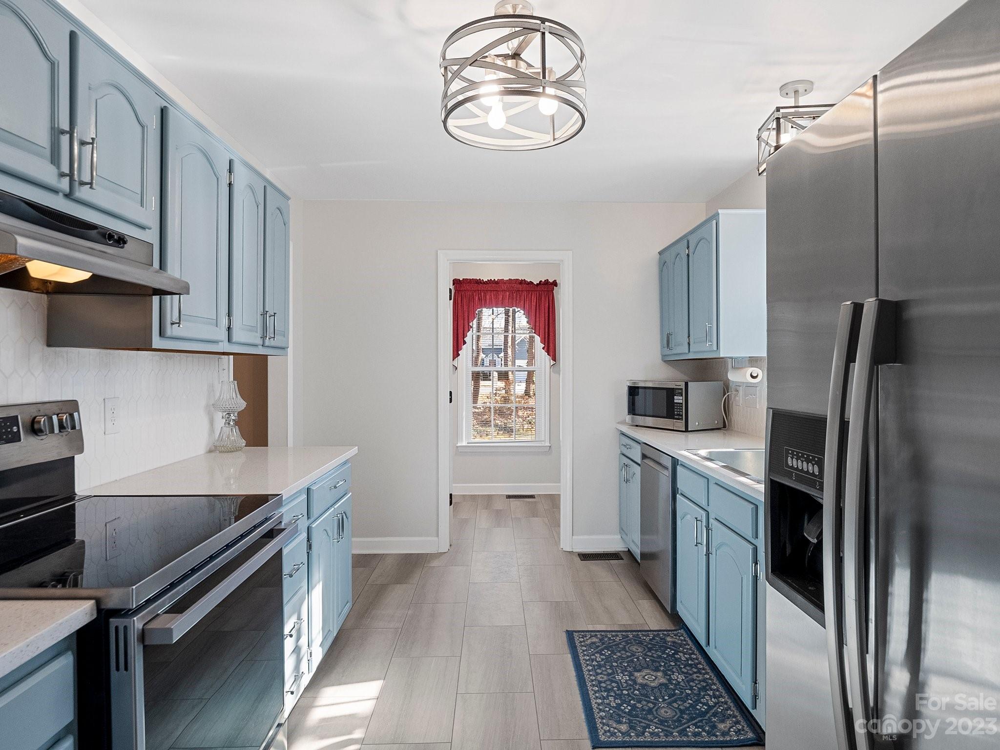 8211 Plott Road Charlotte, NC 28215 - Photo 14 of 38 a kitchen with stainless steel appliances a stove a sink and a refrigerator