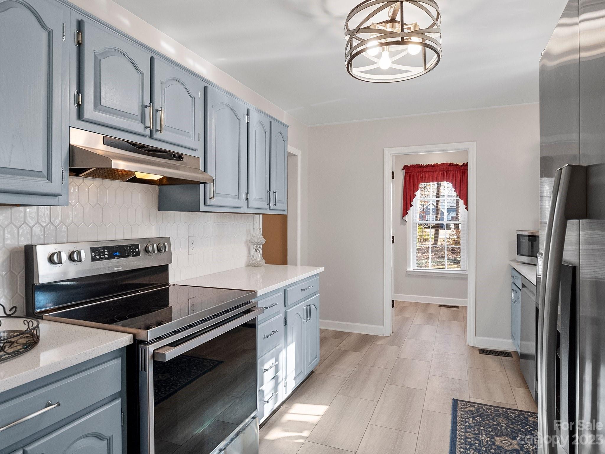 8211 Plott Road Charlotte, NC 28215 - Photo 15 of 38 a kitchen with stainless steel appliances granite countertop a stove and a refrigerator
