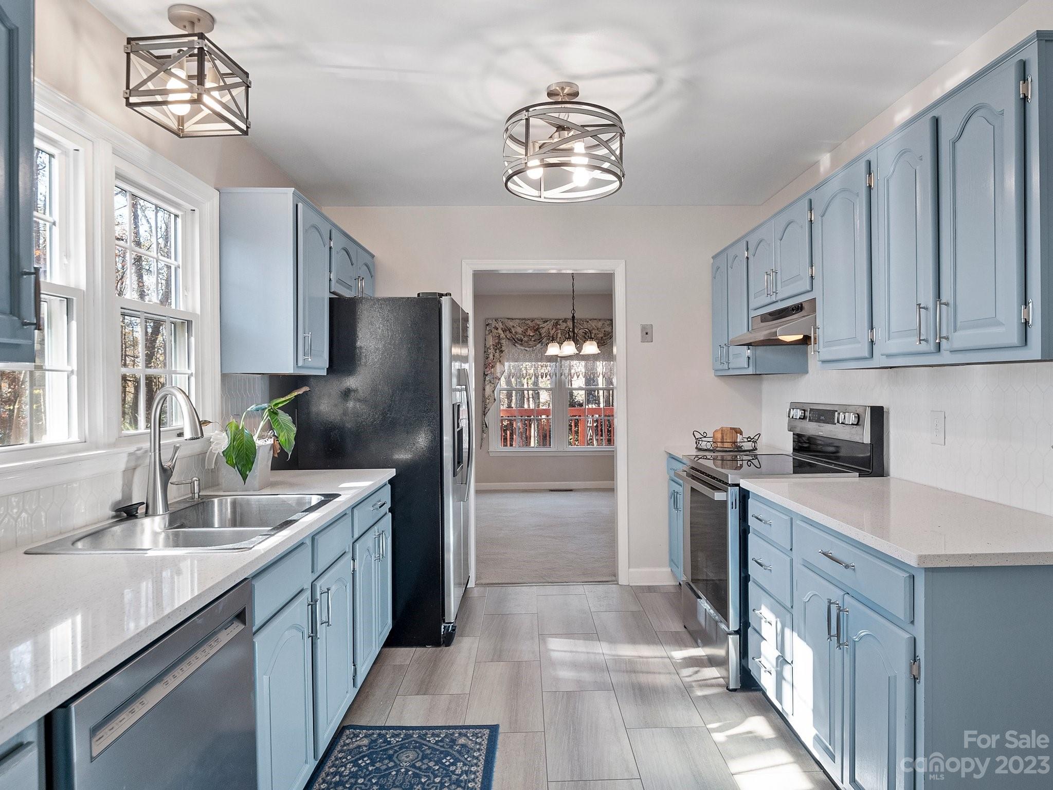 8211 Plott Road Charlotte, NC 28215 - Photo 16 of 38 a kitchen with a refrigerator and a sink