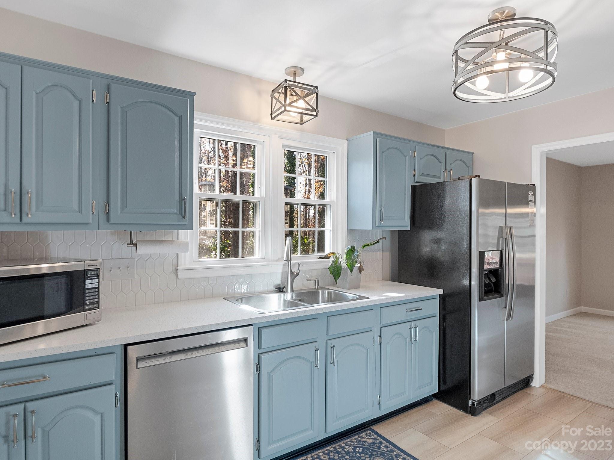 8211 Plott Road Charlotte, NC 28215 - Photo 17 of 38 a kitchen with stainless steel appliances granite countertop a sink and cabinets