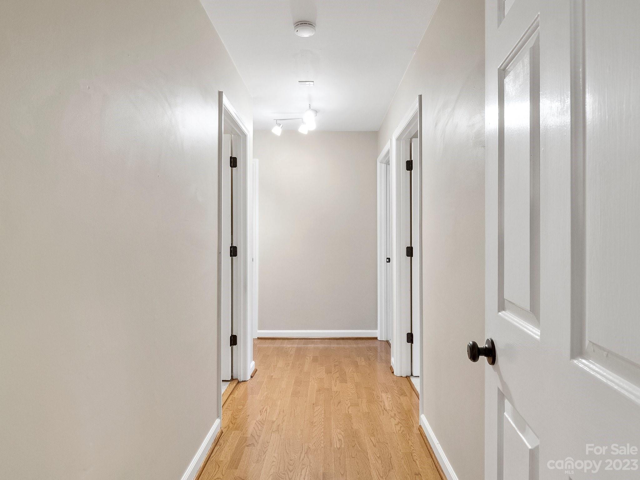 8211 Plott Road Charlotte, NC 28215 - Photo 20 of 38 a view of a hallway with wooden floor and a glass door