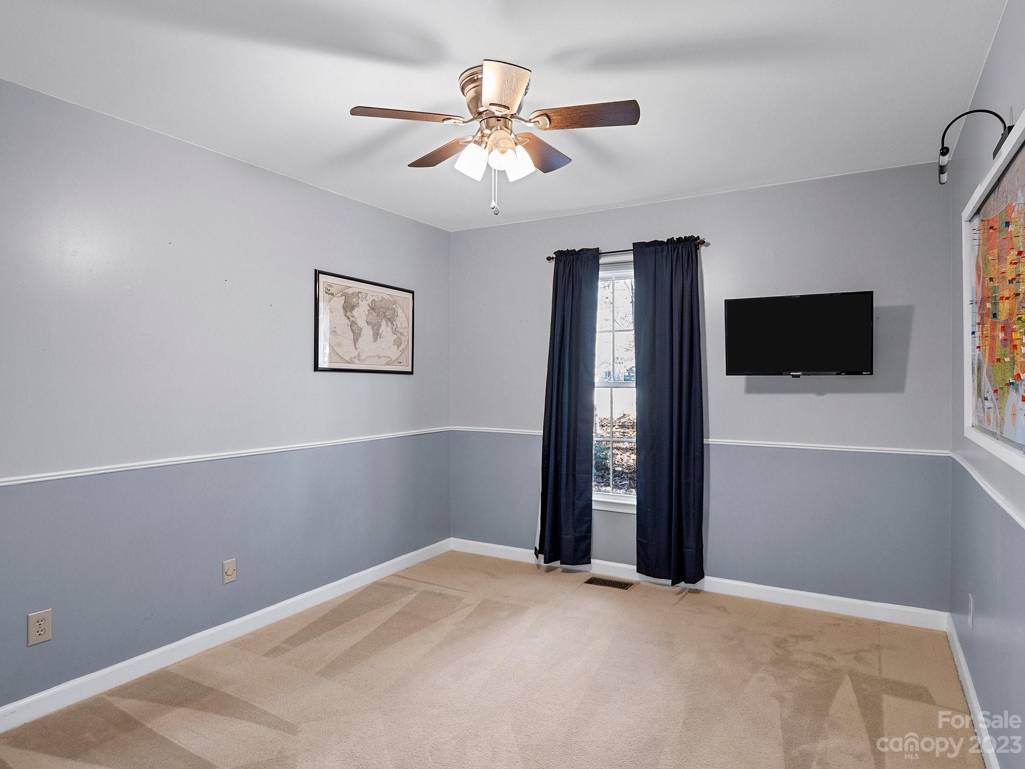 8211 Plott Road Charlotte, NC 28215 - Photo 22 of 38 a view of an empty room with a ceiling fan