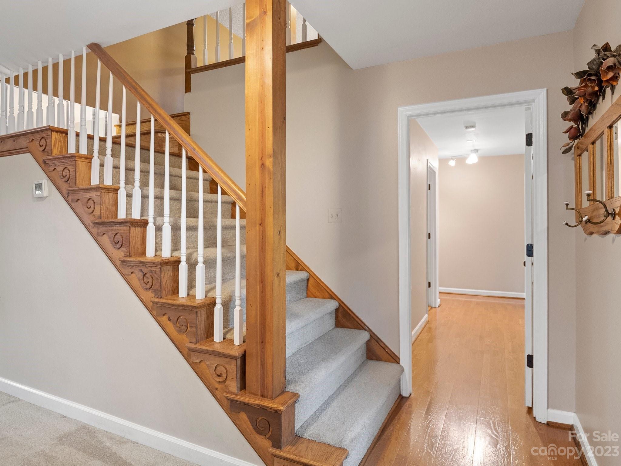 8211 Plott Road Charlotte, NC 28215 - Photo 26 of 38 a view of staircase with wooden floor and white walls