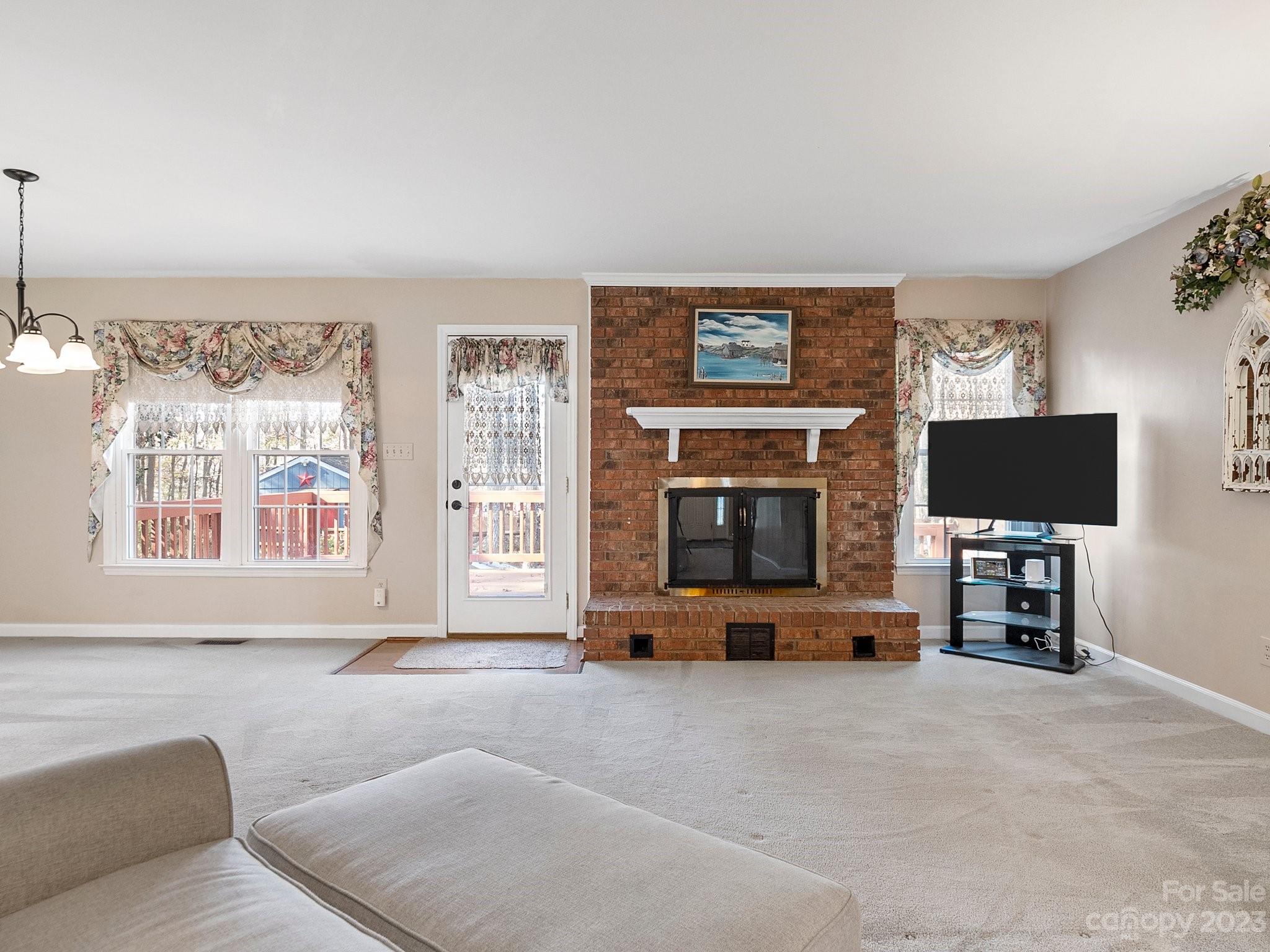 8211 Plott Road Charlotte, NC 28215 - Photo 8 of 38 a living room with furniture and a flat screen tv