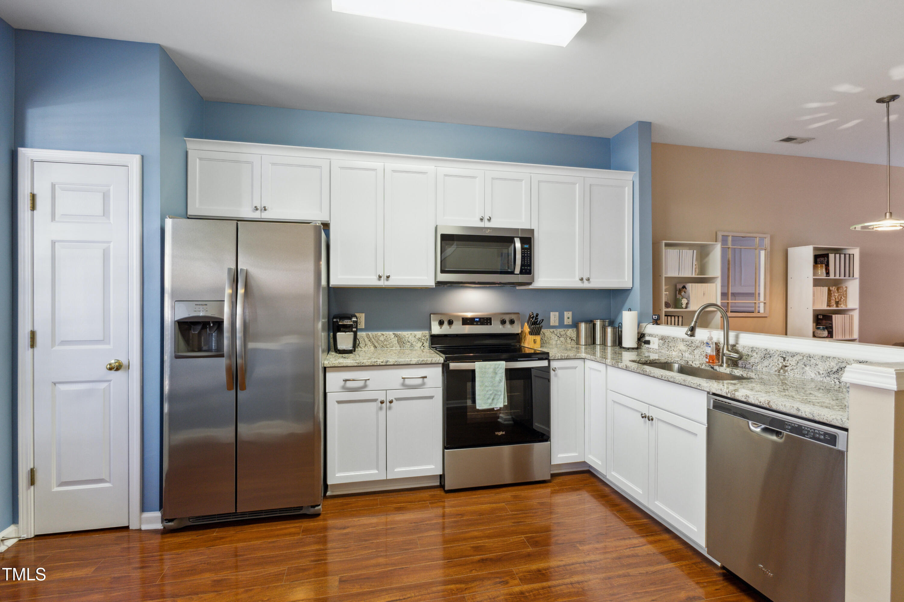 1824 Natalie Brook Way Raleigh, NC 27609 - Photo 11 of 28 a kitchen with stainless steel appliances granite countertop a refrigerator stove a sink and white cabinets