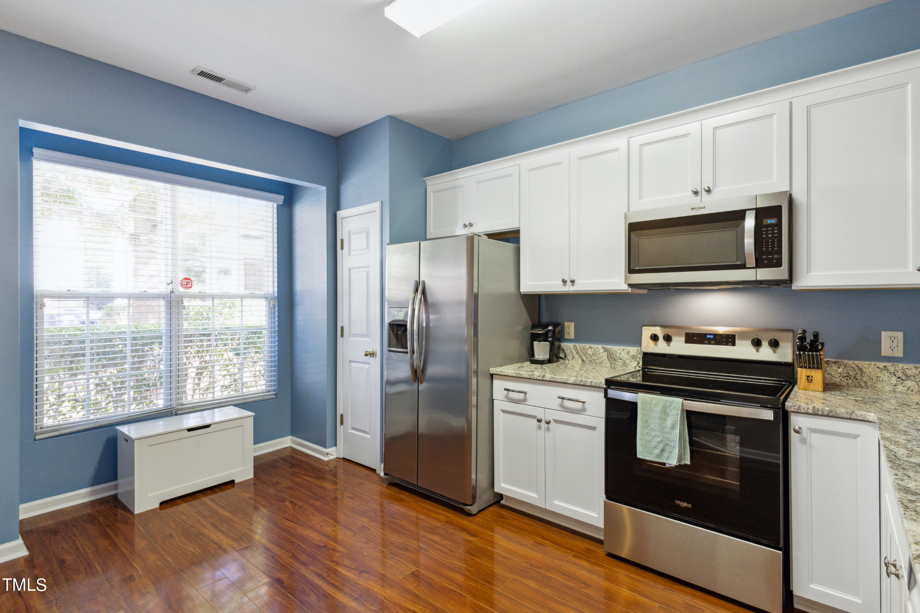 1824 Natalie Brook Way Raleigh, NC 27609 - Photo 12 of 28 a kitchen with stainless steel appliances a stove a sink and a microwave
