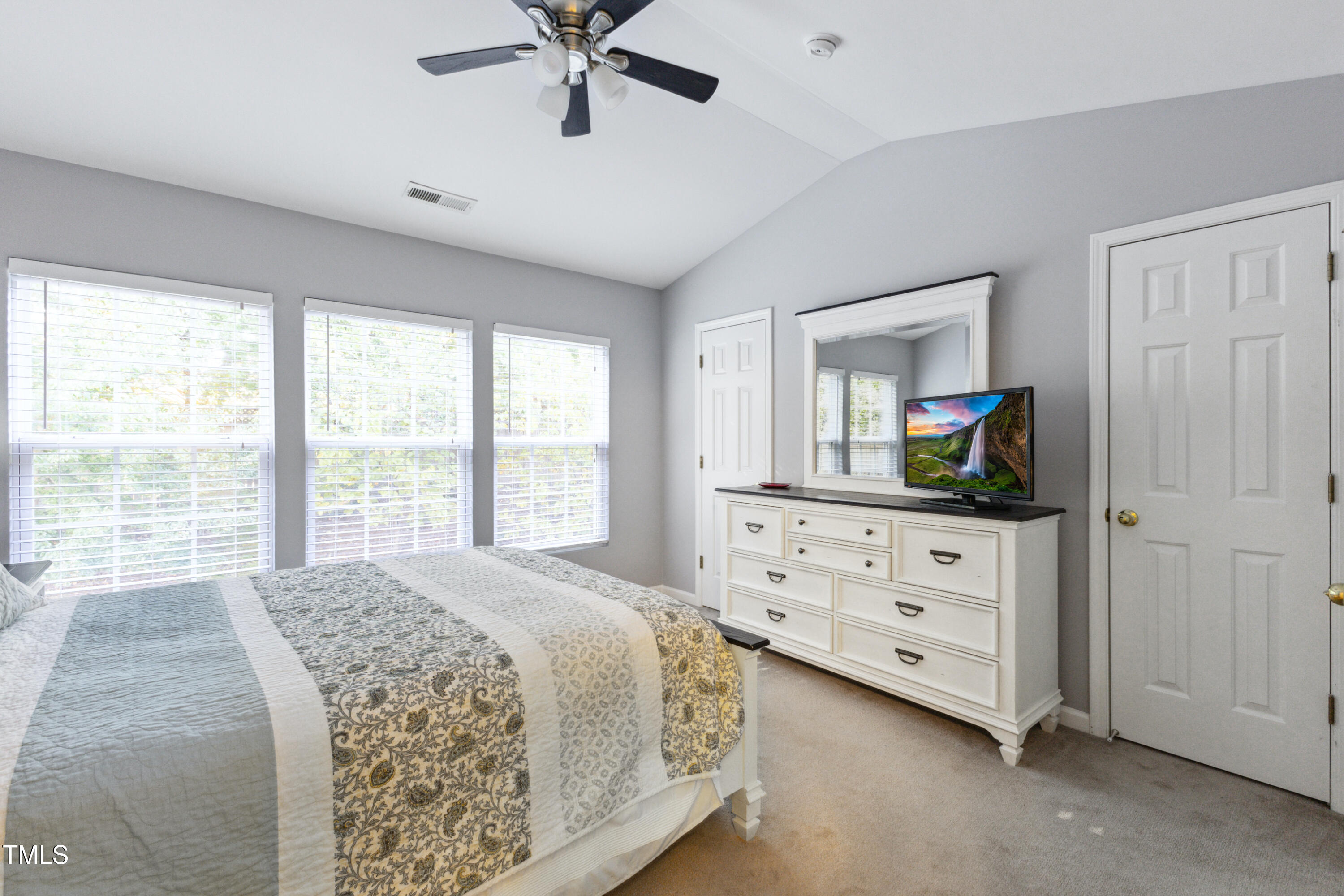 1824 Natalie Brook Way Raleigh, NC 27609 - Photo 17 of 28 a bedroom with a bed a window and dresser