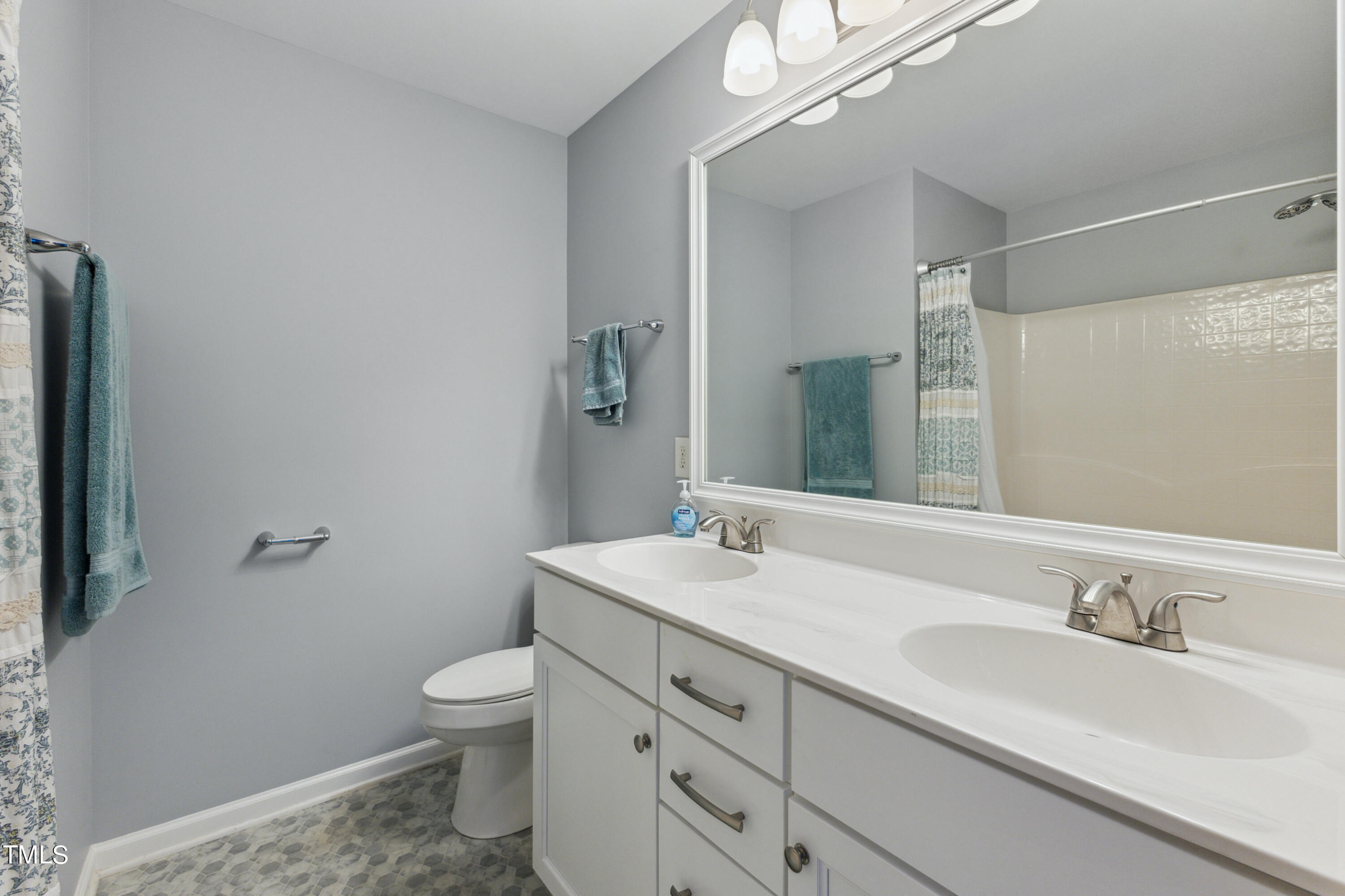1824 Natalie Brook Way Raleigh, NC 27609 - Photo 18 of 28 a bathroom with a granite countertop sink a toilet and a mirror