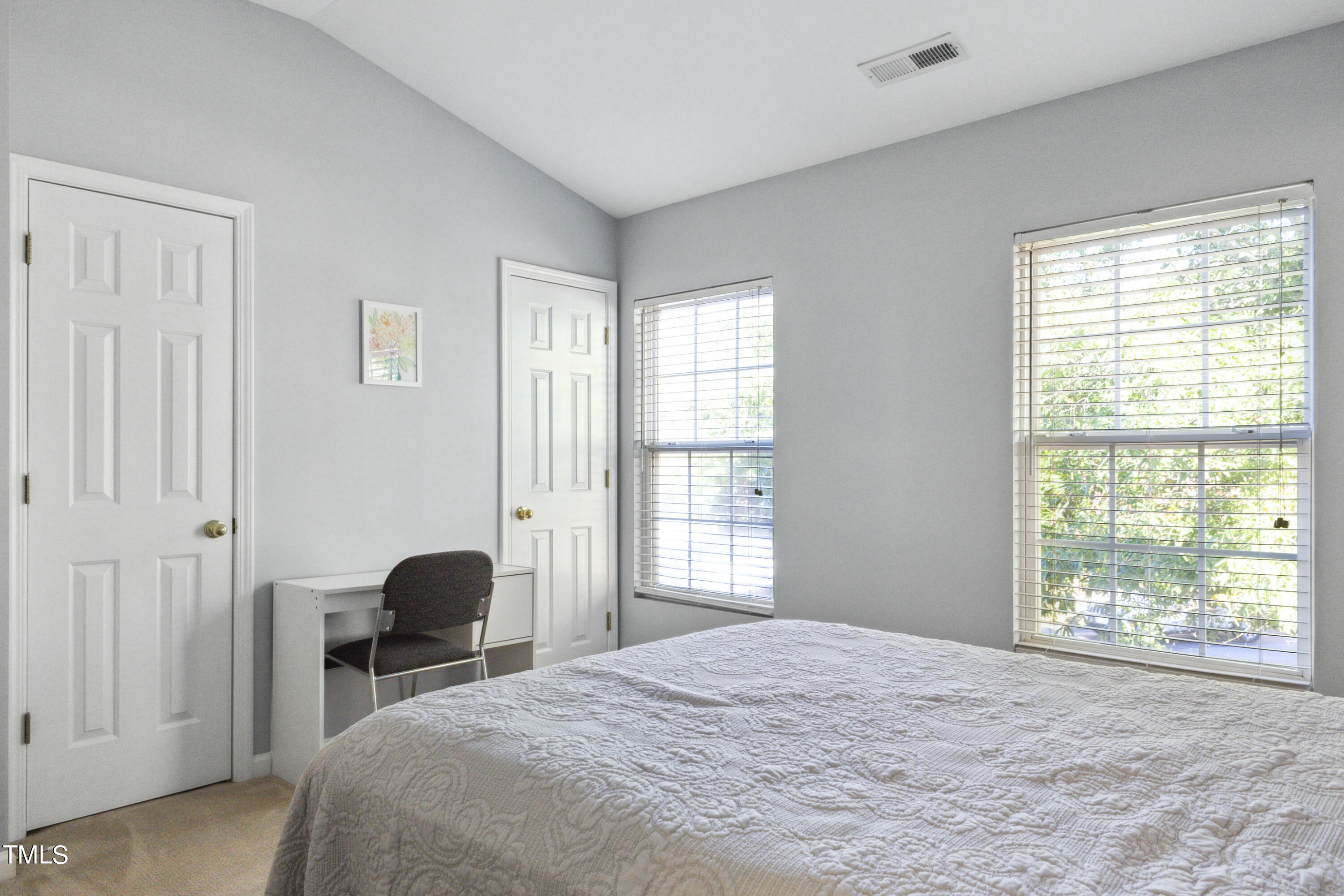 1824 Natalie Brook Way Raleigh, NC 27609 - Photo 23 of 28 a bedroom with a bed a chandelier and a window