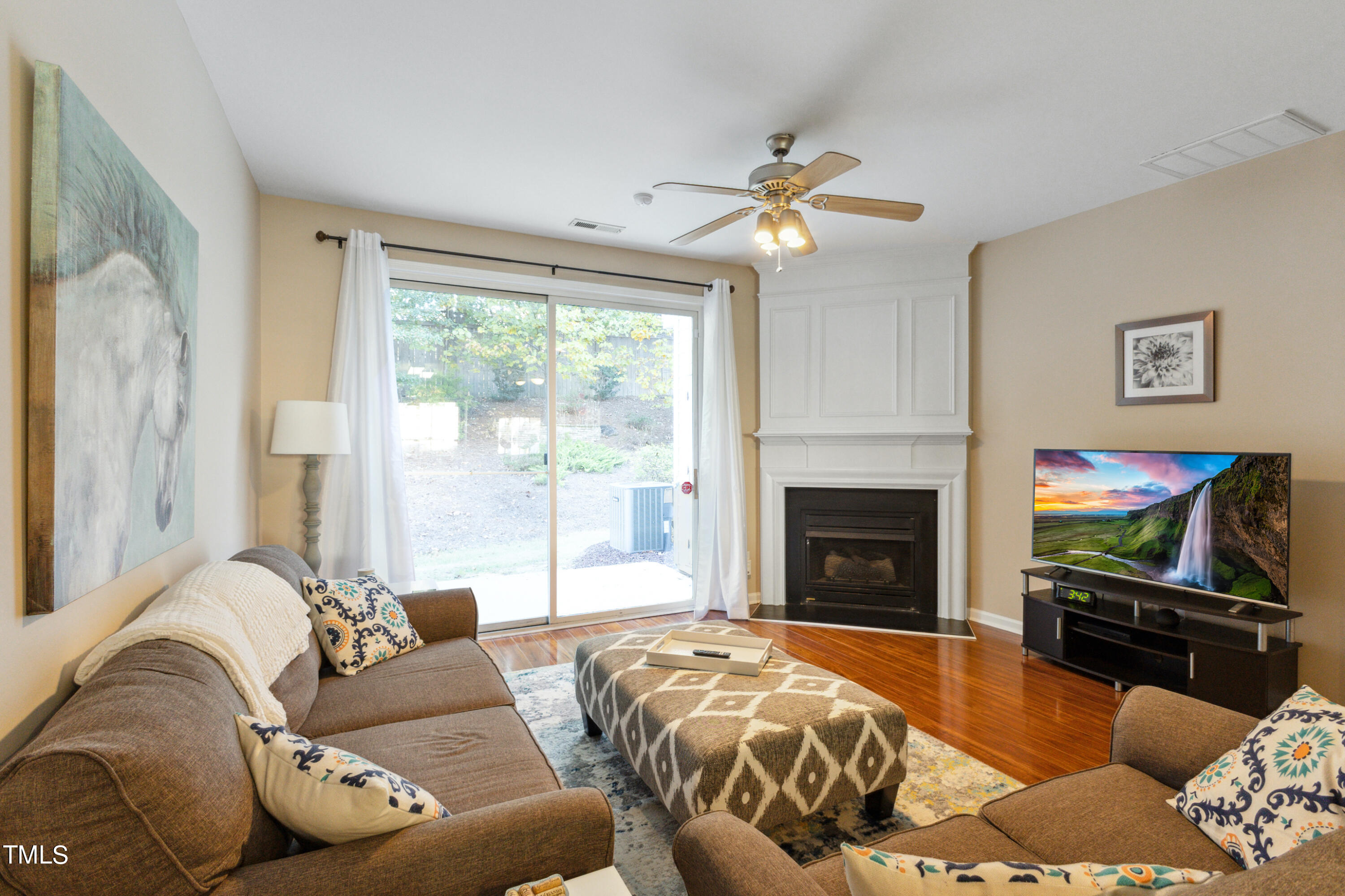 1824 Natalie Brook Way Raleigh, NC 27609 - Photo 4 of 28 a living room with furniture a fireplace and a flat screen tv